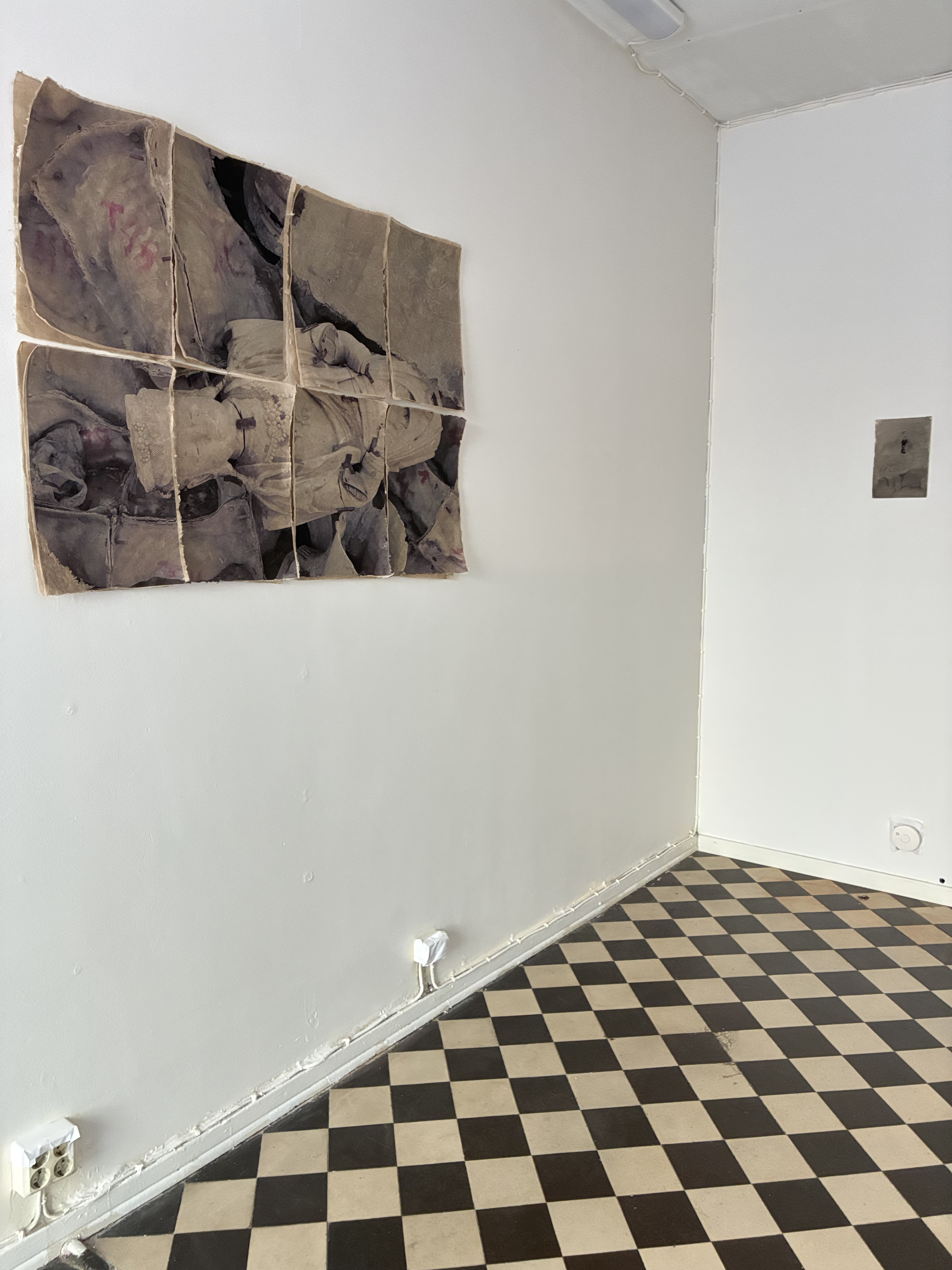 Manufacturing Gods, installation view with works on paper and a checkerboard floor
